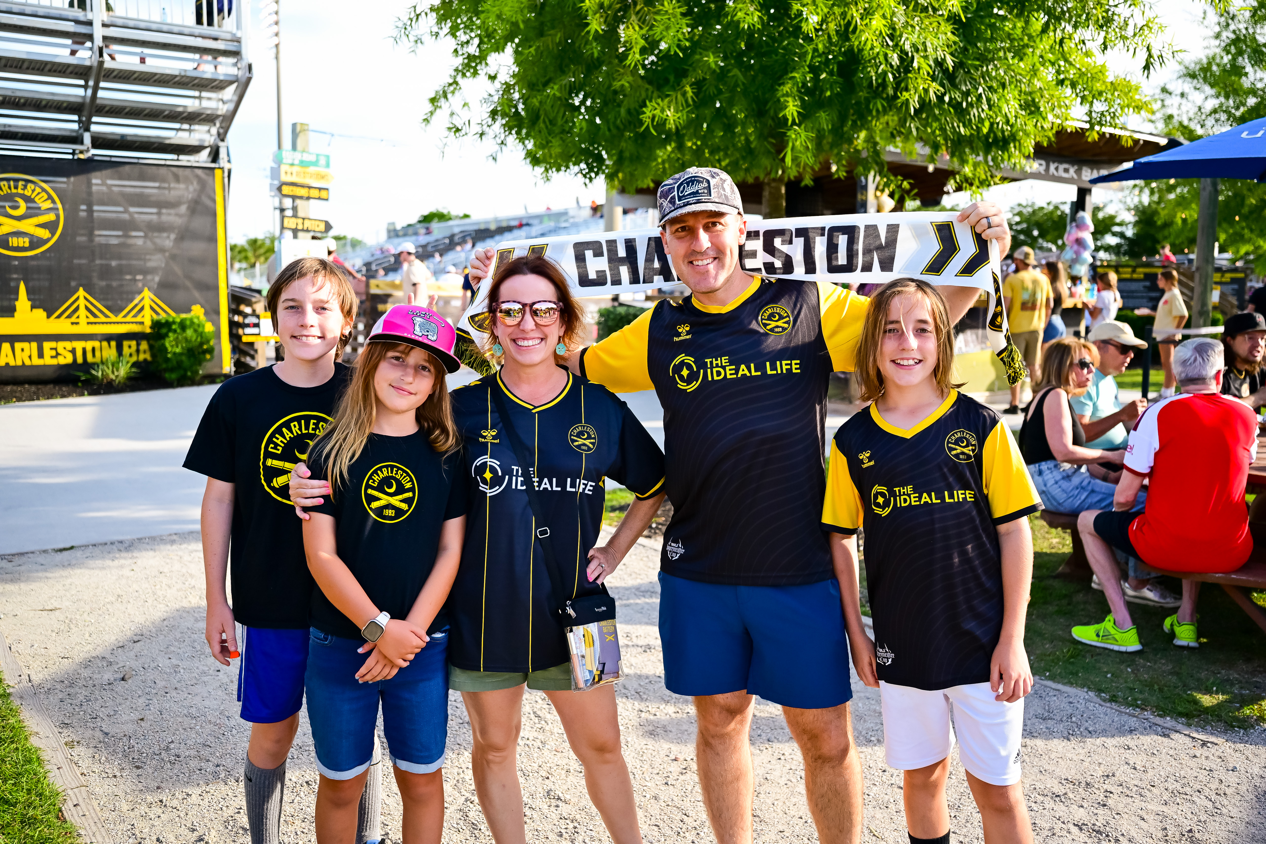 A family supporting the Charleston Battery with a Charleston scarf